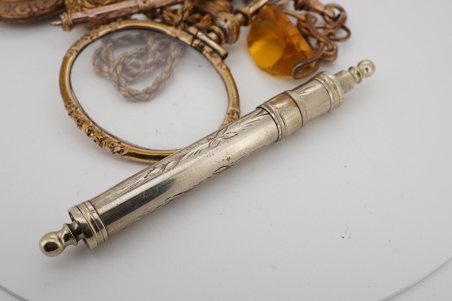 A gilt metal mounted eye glass, pencil and fob seal, suspended from a gilt metal albertina, a pendant and a propelling pen.